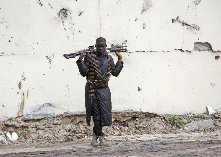 A Somali soldier stands at the scene of a suicide car bomb near the port in Mogadishu, Somalia Saturday, July 4, 2020.  (AP Photo/Farah Abdi Warsameh)